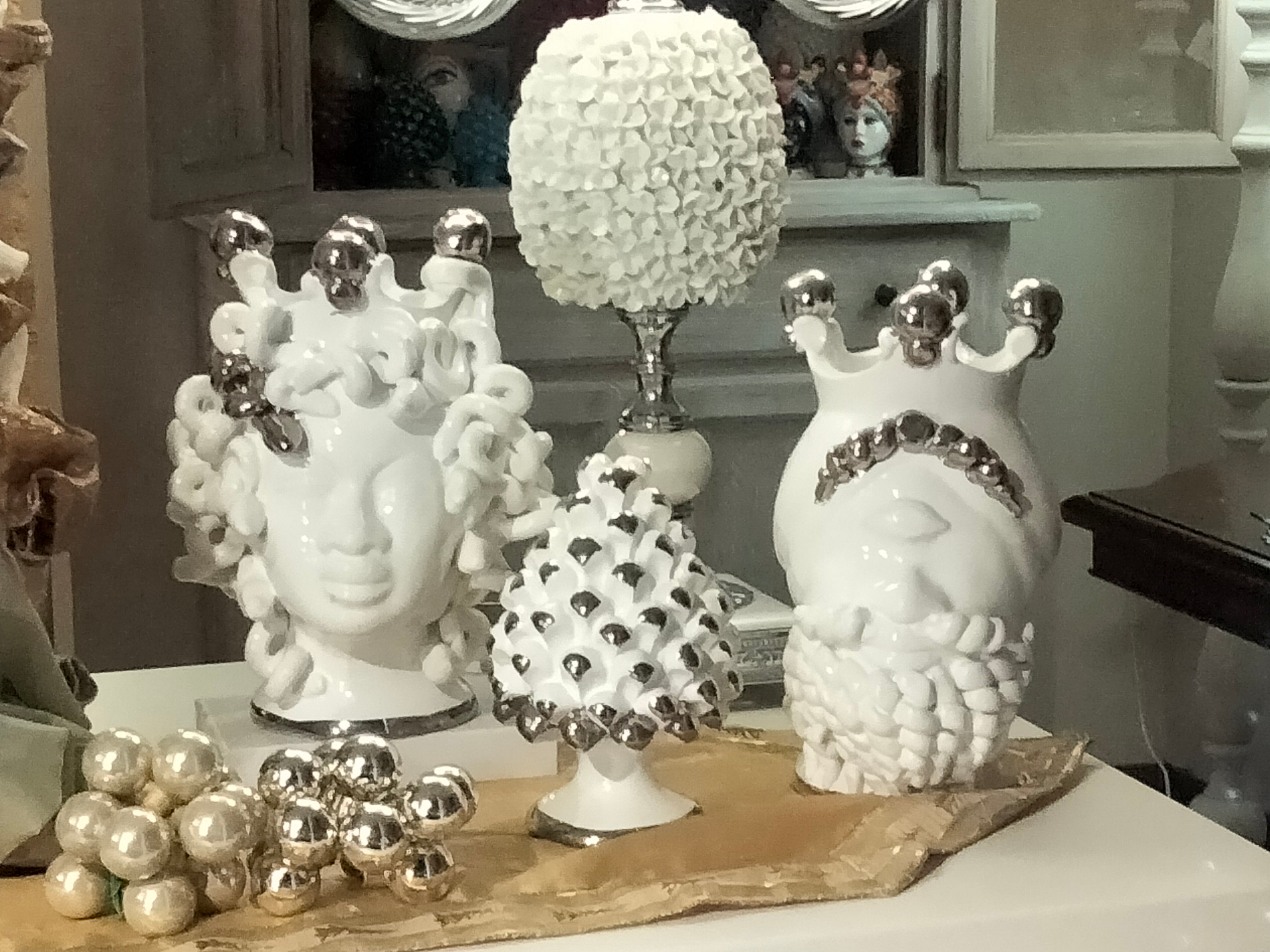 Pair of Medusa and Polyphemus heads in white and platinum