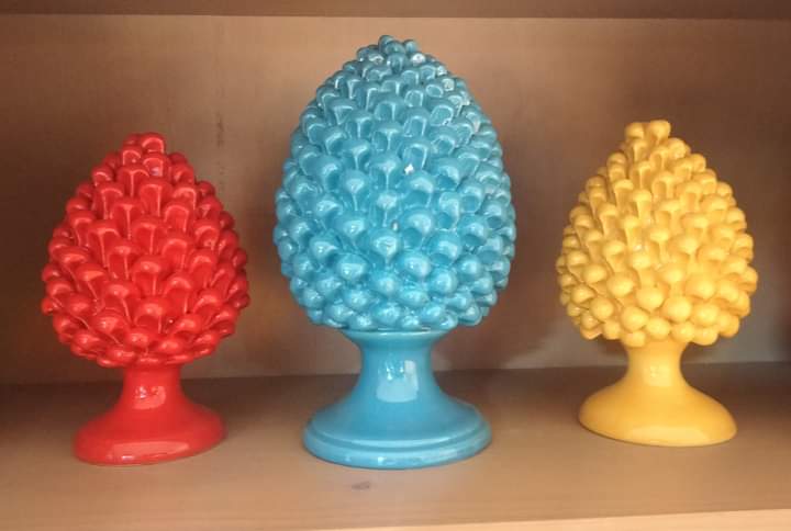Trio of blue, red and yellow pine cones