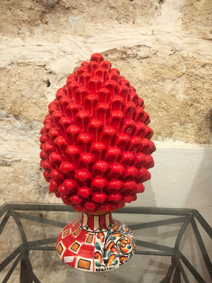 Red pine cone with decorated base