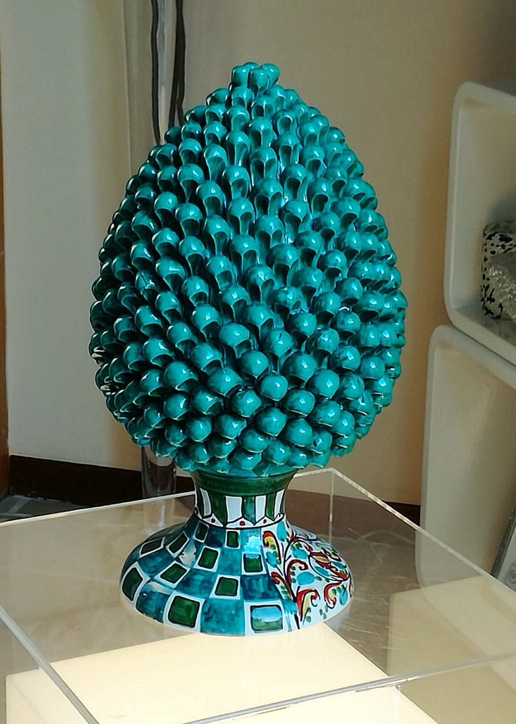 Green pine cone with decorated base